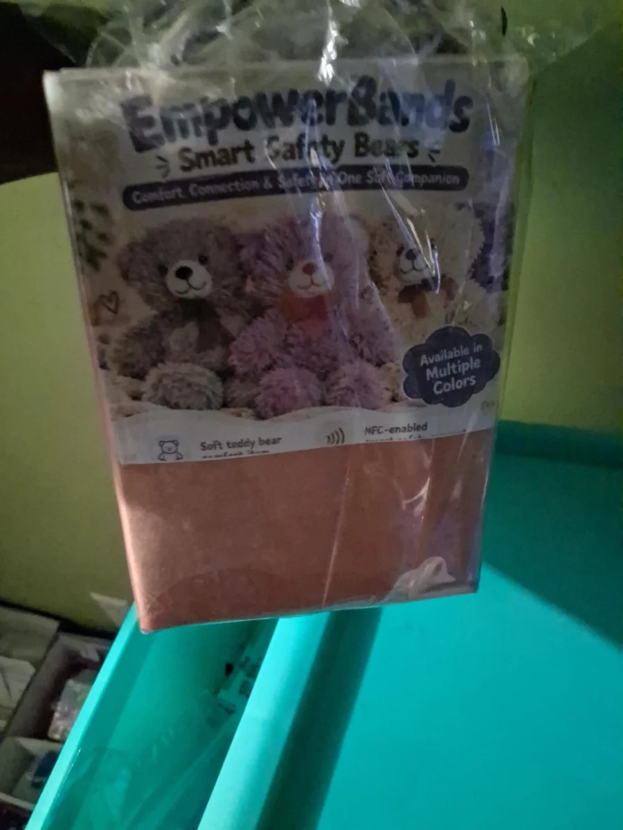 Actual EmpowerBands Smart Safety Bears information card on the packaged bear